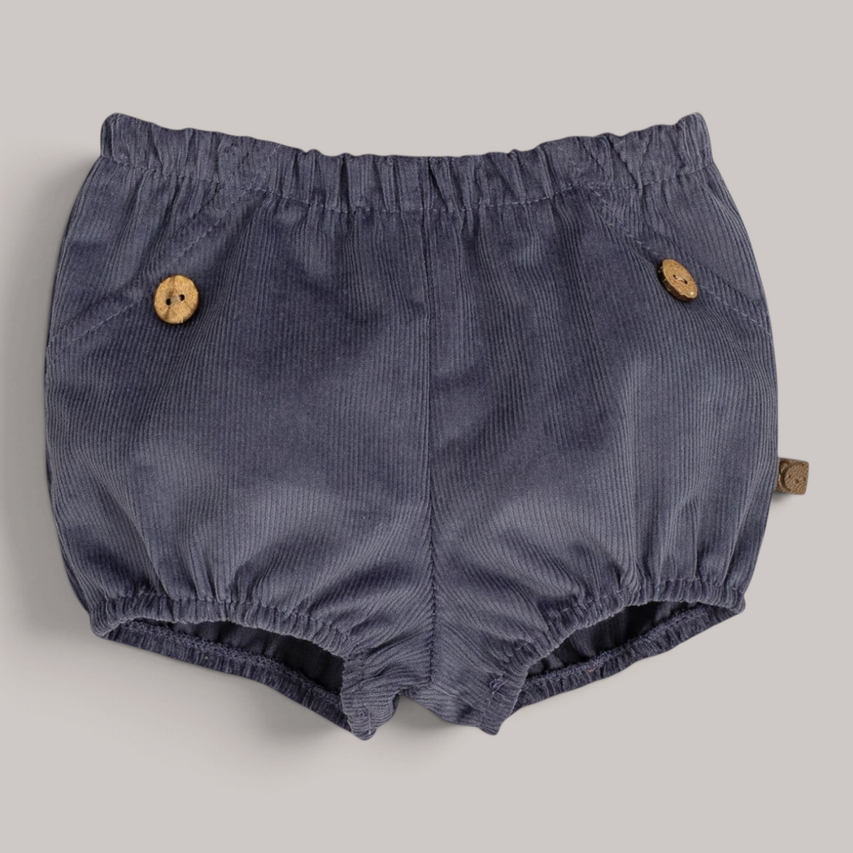 Pololo Pampero de pana gris de NAVIA con botones de madera y cintura elástica para bebé