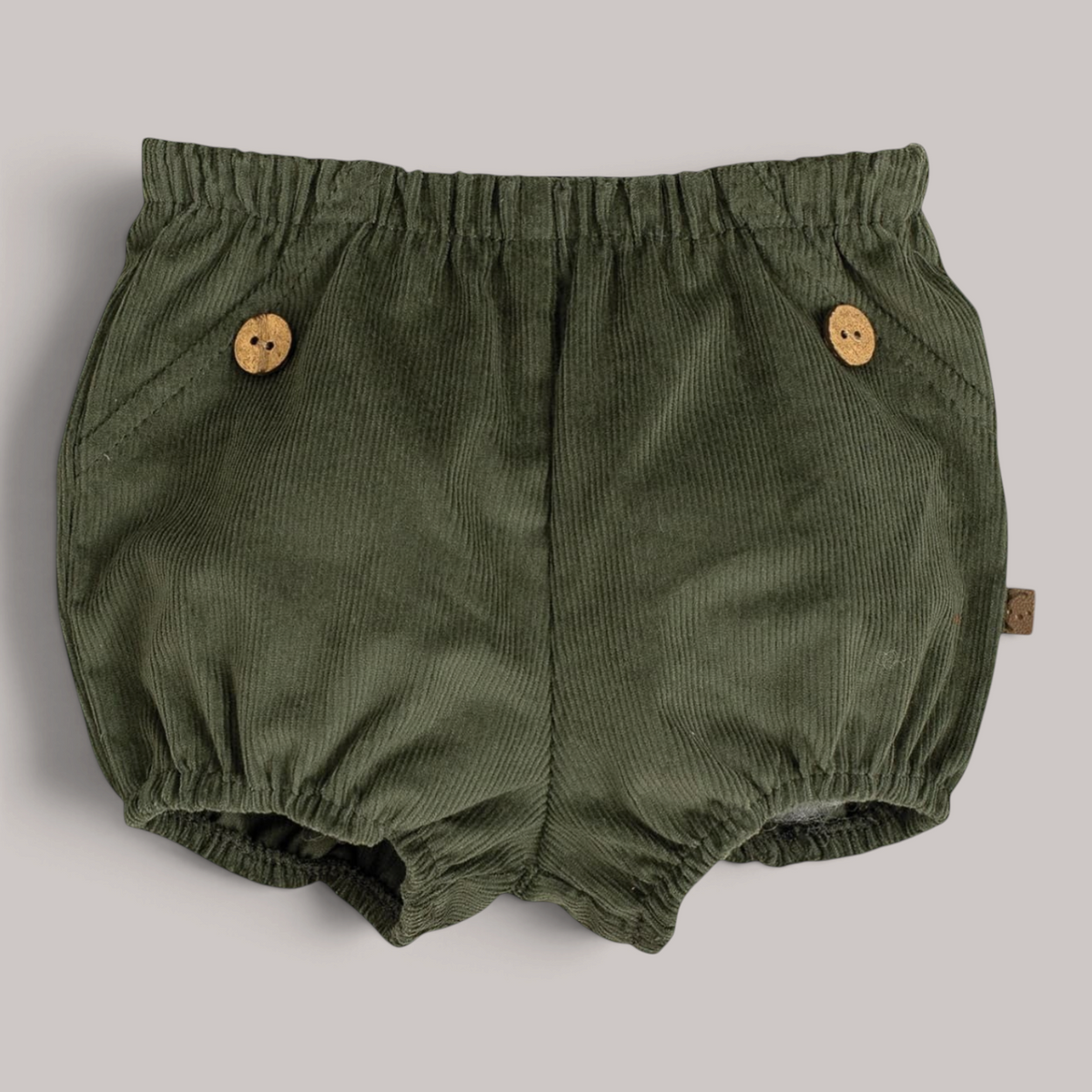 Pololo Pampero de pana verde NAVIA para bebé con botones de madera decorativos y cintura elástica cómoda