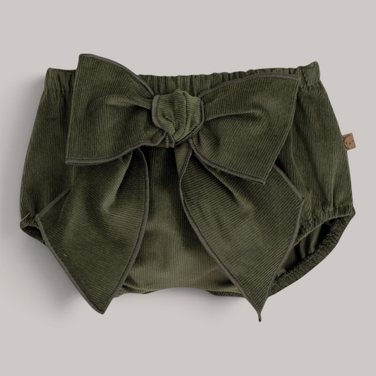 Pololo de bebé NAVIA en pana fina color verde con un gran lazo decorativo en la parte frontal